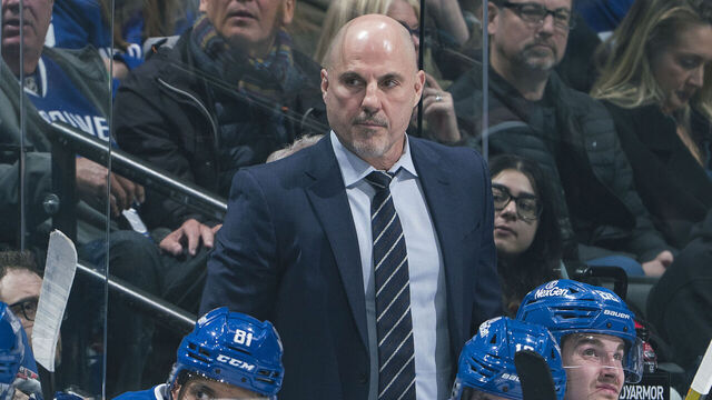 VANCOUVER, CANADA - MARCH 16: Head coach Rick Tocchet of the Vancouver Canucks looks on from the bench during their NHL game against the Utah Hockey Club at Rogers Arena on March 16, 2025 in Vancouver, British Columbia, Canada.