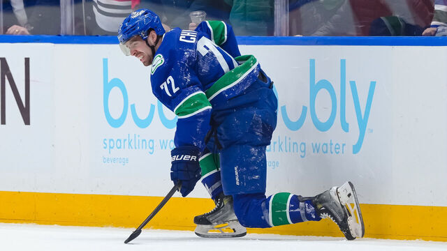 VANCOUVER, CANADA - MARCH 15: Filip Chytil #72 of the Vancouver Canucks struggles to get up after a hit during the third period of their NHL game against the Chicago Blackhawks at Rogers Arena on March 15, 2025 in Vancouver, British Columbia, Canada.