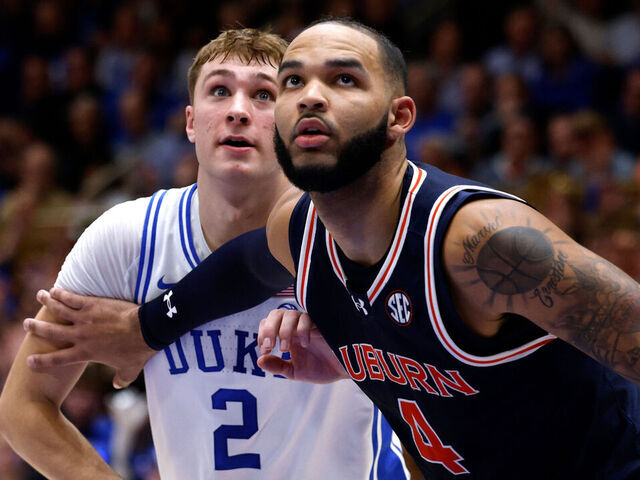 DURHAM, NORTH CAROLINA - DECEMBER 4: Johni Broome #4 of the Auburn Tigers boxes out against Cooper Flagg #2 of the Duke Blue Devils during the first half of the game at Cameron Indoor Stadium on December 4, 2024 in Durham, North Carolina.
