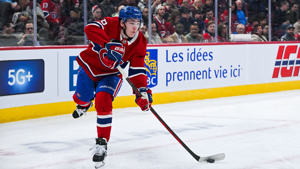 MONTREAL, QC - APRIL 01: Montreal Canadiens defenseman Lane Hutson (48) shoots the puck away during the Florida Panthers versus the Montreal Canadiens game on April 01, 2025, at Bell Centre in Montreal, QC