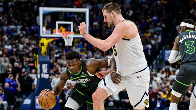 DENVER, COLORADO - APRIL 1: Anthony Edwards #5 of the Minnesota Timberwolves is defended by Nikola Jokic #15 of the Denver Nuggets in overtime of a game at Ball Arena on April 1, 2025 in Denver, Colorado.