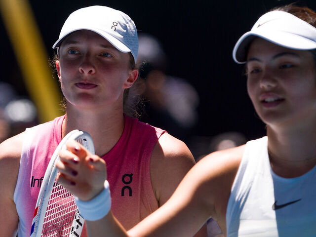MELBOURNE, AUSTRALIA - JANUARY 18: Iga Swiatek (L) of Poland greets Emma Raducanu of Great Britain at the net after victory in the Women's Singles Third Round match during day seven of the 2025 Australian Open at Melbourne Park on January 18, 2025 in Melbourne, Australia.