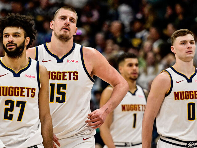 DENVER, COLORADO - MARCH 15: Nikola Jokic #15 of the Denver Nuggets reacts as he is surrounded by teammates Jamal Murray #27, Christian Braun #0, Michael Porter Jr. #1, and Russell Westbrook #4 in the second half against the Washington Wizards at Ball Arena on March 15, 2025 in Denver, Colorado.