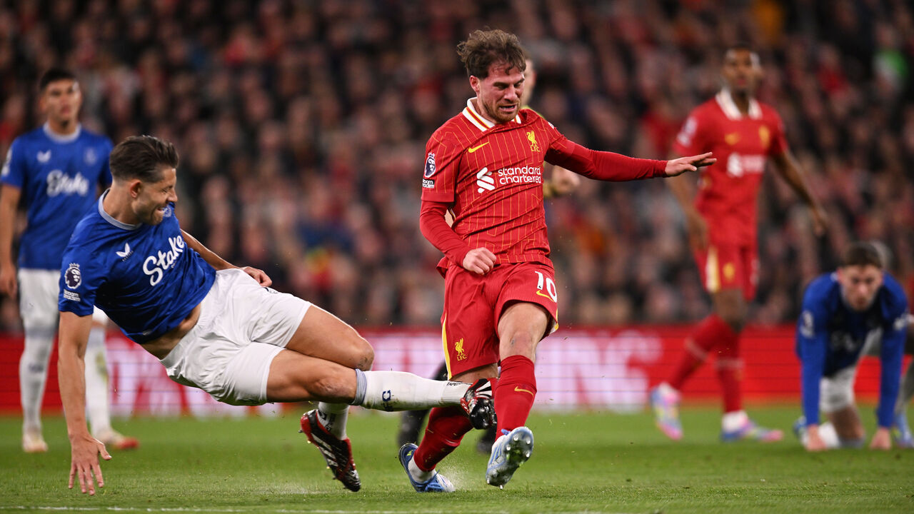 LIVERPOOL, ENGLAND - APRIL 02: (THE SUN OUT, THE SUN ON SUNDAY OUT) Alexis Mac Allister of Liverpool is fouled by James Tarkowski of Everton during the Premier League match between Liverpool FC and Everton FC at Anfield on April 02, 2025 in Liverpool, England.