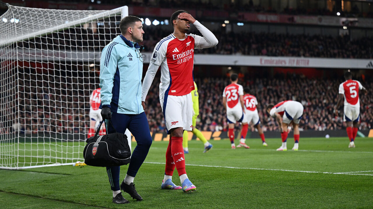 LONDON, ENGLAND - APRIL 01: Gabriel of Arsenal looks dejected as he leaves the pitch with a member of the medical team after picking up an injury during the Premier League match between Arsenal FC and Fulham FC at Emirates Stadium on April 01, 2025 in London, England.