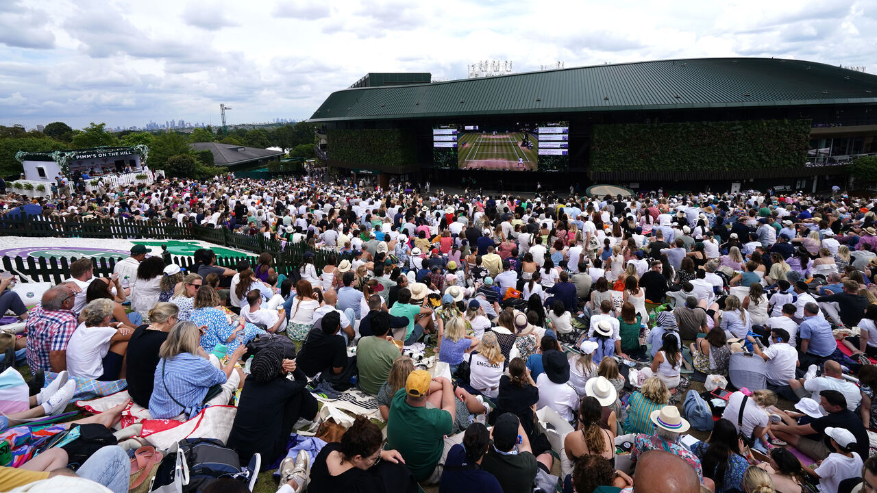 Spectators on the hill outside Court One ahead of the Gentlemen's Singles Final between Carlos Alcaraz and Novak Djokovic on day fourteen of the 2024 Wimbledon Championships at the All England Lawn Tennis and Croquet Club, London. Picture date: Sunday July 14, 2024.