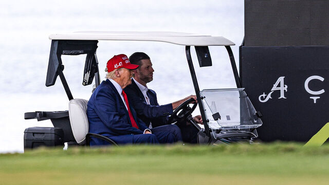 DORAL, FLORIDA - APRIL 03: U.S. President Donald Trump and his son Eric Trump drive in a golf cart after arriving on Marine One on the ninth hole during previews for LIV Golf Miami at Trump National Doral Miami on April 03, 2025 in Doral, Florida.