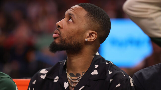 PHOENIX, ARIZONA - MARCH 24: Damian Lillard #0 of the Milwaukee Bucks looks on from the bench during the first half against the Phoenix Suns at PHX Arena on March 24, 2025 in Phoenix, Arizona.
