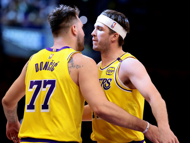 LOS ANGELES, CALIFORNIA - MARCH 19: Luka Doncic #77 of the Los Angeles Lakers celebrates a three-point basket with teammate Austin Reaves #15 during the first quarter against the Denver Nuggets at Crypto.com Arena on March 19, 2025 in Los Angeles, California.