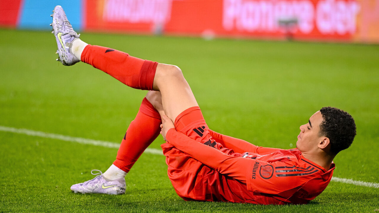Augsburg, Germany - April 4: Jamal Musiala of Bayern Muenchen injured on the ground during the Bundesliga match between FC Augsburg and FC Bayern München at WWK ARENA on April 4, 2025 in Augsburg, Germany.