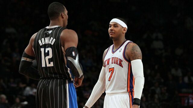 NEW YORK, NY - JANUARY 16: (NEW YORK DAILIES OUT) Carmelo Anthony #7 of the New York Knicks talks with Dwight Howard #12 of the Orlando Magic on January 16, 2012 at Madison Square Garden in New York City. The Magic defeated the Knicks 102-93. NOTE TO USER: User expressly acknowledges and agrees that, by downloading and/or using this Photograph, user is consenting to the terms and conditions of the Getty Images License Agreement.