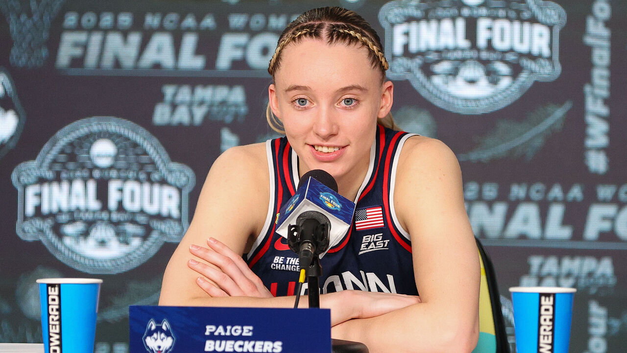 TAMPA, FL - APRIL 04: UConn Huskies guard Paige Bueckers (5) peaks with the media at the conclusion of the 2025 NCAA Div I Women's Championship Final Four game between UConn Huskies and UCLA Bruins on April 4, 2025, at Amalie Arena in Tampa, FL.