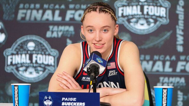 TAMPA, FL - APRIL 04: UConn Huskies guard Paige Bueckers (5) peaks with the media at the conclusion of the 2025 NCAA Div I Women's Championship Final Four game between UConn Huskies and UCLA Bruins on April 4, 2025, at Amalie Arena in Tampa, FL.