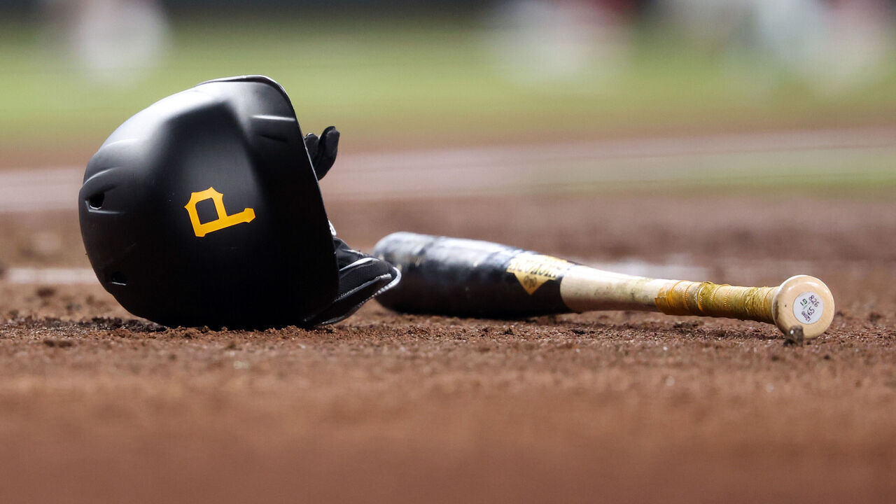 PHOENIX, ARIZONA - JULY 28: Close up of a batting helmet with the Pittsburgh Pirates logo and a bat during the game against the Arizona Diamondbacks at Chase Field on July 28, 2024 in Phoenix, Arizona. The Pirates defeated the Diamondbacks 6-5 in 10 innings.
