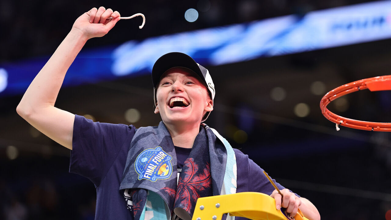 TAMPA, FLORIDA - APRIL 06: Paige Bueckers #5 of the UConn Huskies celebrates with a piece of the net after beating the South Carolina Gamecocks 82-59 to win the National Championship of the NCAA Women's Basketball Tournament at Amalie Arena on April 06, 2025 in Tampa, Florida.