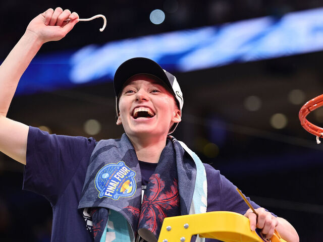 TAMPA, FLORIDA - APRIL 06: Paige Bueckers #5 of the UConn Huskies celebrates with a piece of the net after beating the South Carolina Gamecocks 82-59 to win the National Championship of the NCAA Women's Basketball Tournament at Amalie Arena on April 06, 2025 in Tampa, Florida.