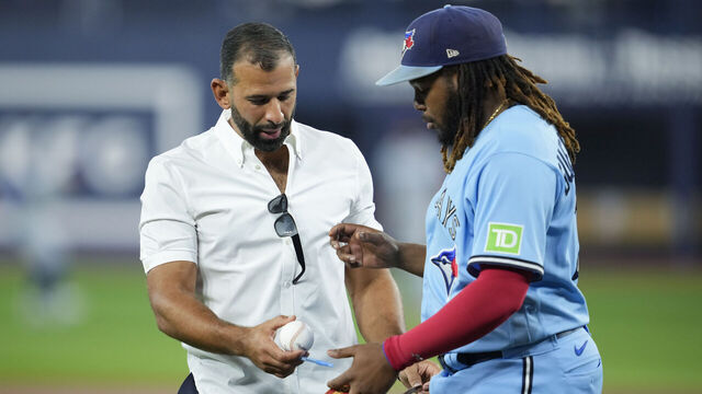 TORONTO, ON - AUGUST 12: Former Toronto Blue Jays Jose Bautista gives Vladimir Guerrero Jr. #27 of the Toronto Blue Jays a signed ball after taking part in a ceremony where his name is unveiled on the Level of Excellence before the Toronto Blue Jays play the Chicago Cubs in their MLB game at the Rogers Centre on August 12, 2023 in Toronto, Canada.