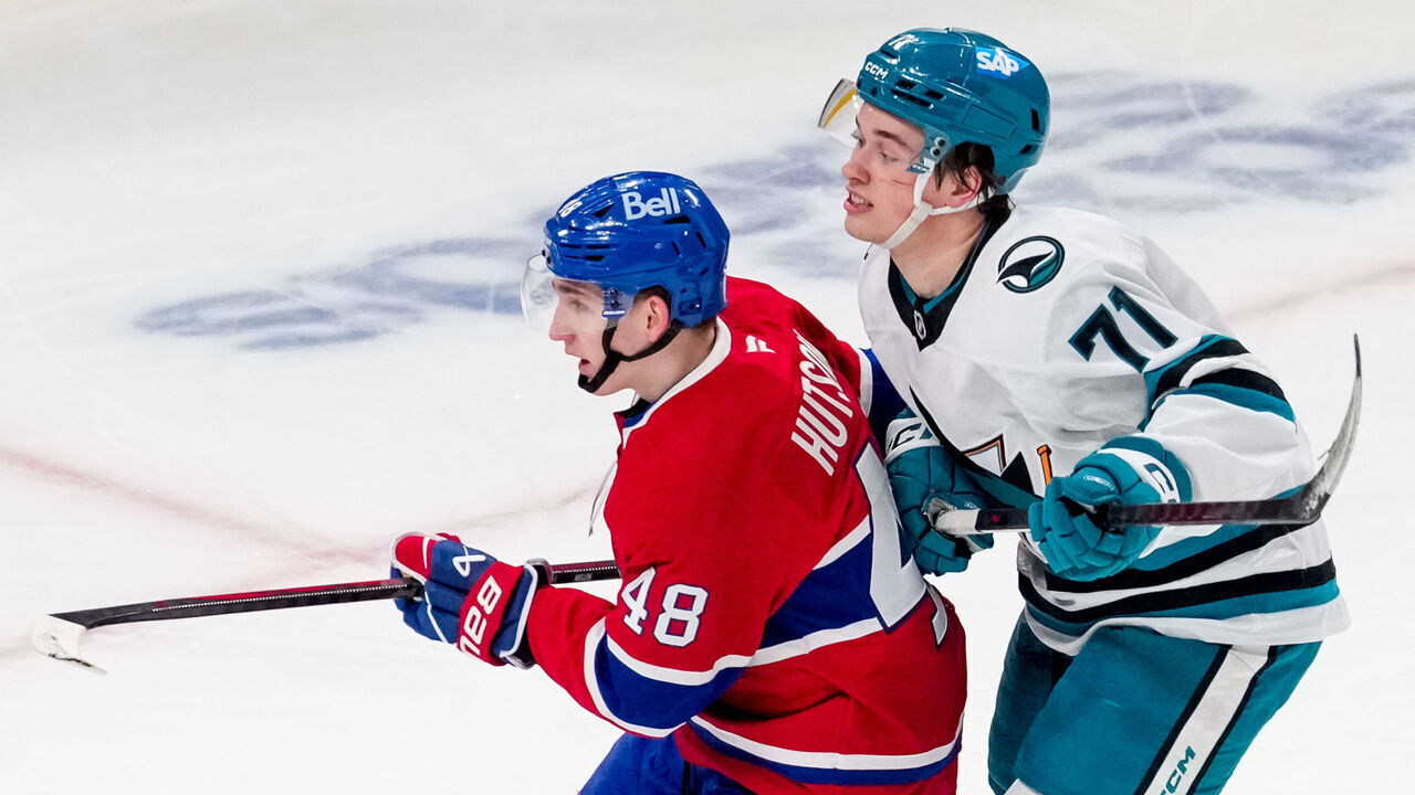 MONTREAL, QUEBEC - FEBRUARY 27: Lane Hutson #48 of the Montreal Canadiens and Macklin Celebrini #71 of the San Jose Sharks fight for position during the second period during a game at Bell Centre on February 27, 2025 in Montreal, Quebec.