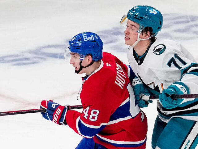 MONTREAL, QUEBEC - FEBRUARY 27: Lane Hutson #48 of the Montreal Canadiens and Macklin Celebrini #71 of the San Jose Sharks fight for position during the second period during a game at Bell Centre on February 27, 2025 in Montreal, Quebec.