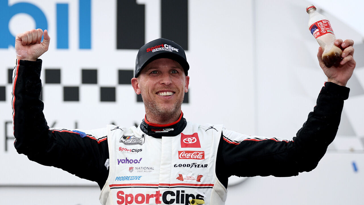 DARLINGTON, SOUTH CAROLINA - APRIL 06: Denny Hamlin, driver of the #11 Sport Clips Haircuts Toyota, celebrates in victory lane after winning the NASCAR Cup Series Goodyear 400 at Darlington Raceway on April 06, 2025 in Darlington, South Carolina.