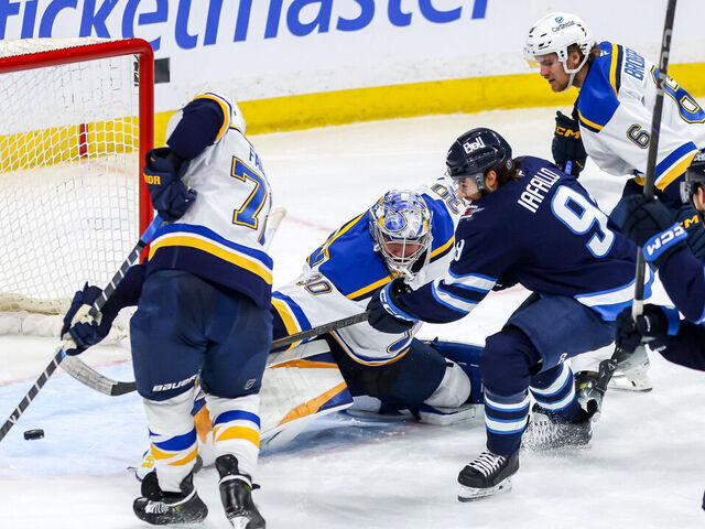 WINNIPEG, CANADA - APRIL 7: Alex Iafallo #9 of the Winnipeg Jets shoots the puck past goaltender Joel Hofer #30 of the St. Louis Blues and into the open net for a third period goal at the Canada Life Centre on April 7, 2025 in Winnipeg, Manitoba, Canada.