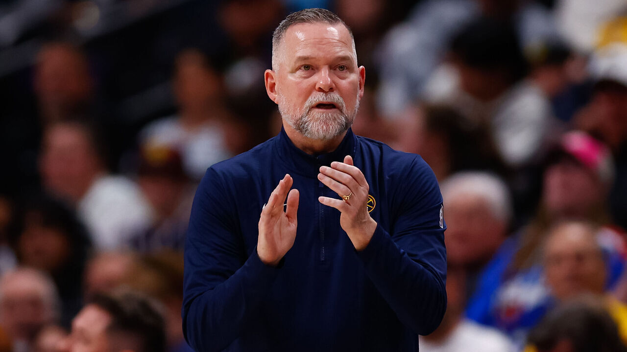 DENVER, CO - APRIL 6: Head Coach Michael Malone claps on the sidelines during the third quarter against the Indiana Pacers at Ball Arena on April 6, 2025 in Denver, Colorado.