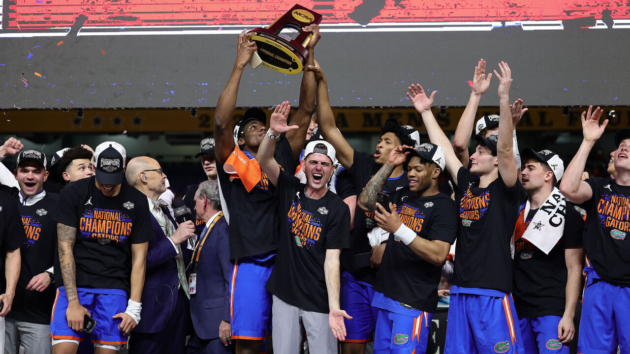 SAN ANTONIO, TEXAS - APRIL 07: Rueben Chinyelu #9 and head coach Todd Golden of the Florida Gators celebrate with the trophy after defeating the Houston Cougars in the National Championship of the NCAA Men's Basketball Tournament at the Alamodome on April 07, 2025 in San Antonio, Texas.