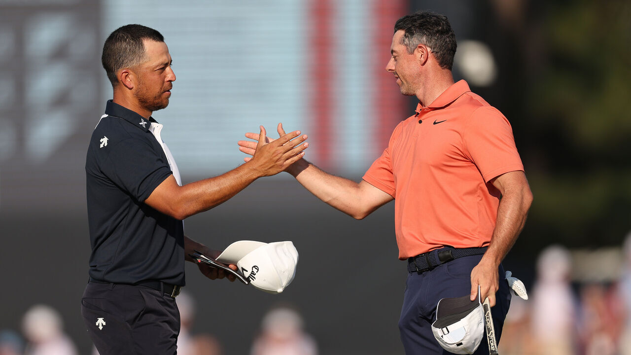 PINEHURST, NORTH CAROLINA - JUNE 13: Xander Schauffele of the United States and Rory McIlroy of Northern Ireland shake hands on the 18th green during the first round of the 124th U.S. Open at Pinehurst Resort on June 13, 2024 in Pinehurst, North Carolina.