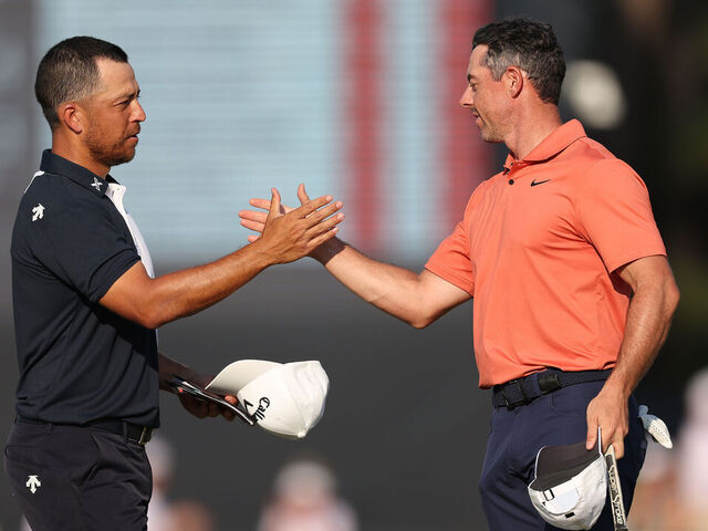 PINEHURST, NORTH CAROLINA - JUNE 13: Xander Schauffele of the United States and Rory McIlroy of Northern Ireland shake hands on the 18th green during the first round of the 124th U.S. Open at Pinehurst Resort on June 13, 2024 in Pinehurst, North Carolina.