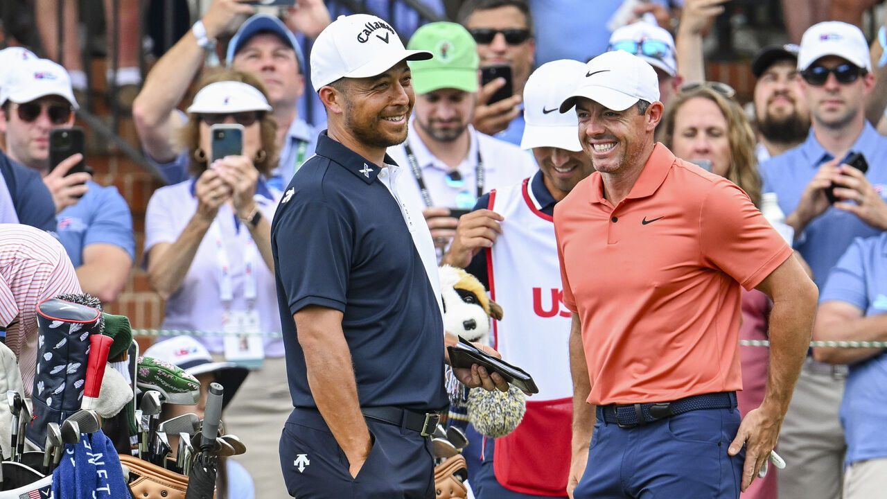 PINEHURST, NORTH CAROLINA - JUNE 13: Xander Schauffele and Rory McIlroy of Northern Ireland smile other on the first tee during the first round of the U.S. Open on the No. 2 Course at Pinehurst Resort on June 13, 2024, in Pinehurst, North Carolina.