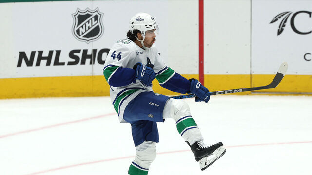 DALLAS, TEXAS - APRIL 08: Kiefer Sherwood #44 of the Vancouver Canucks celebrates after scoring the game winning goal in overtime to defeat the Dallas Stars at American Airlines Center on April 08, 2025 in Dallas, Texas.