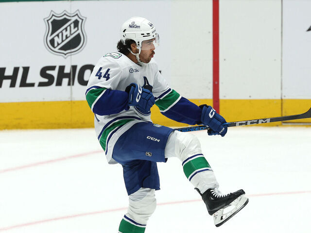 DALLAS, TEXAS - APRIL 08: Kiefer Sherwood #44 of the Vancouver Canucks celebrates after scoring the game winning goal in overtime to defeat the Dallas Stars at American Airlines Center on April 08, 2025 in Dallas, Texas.