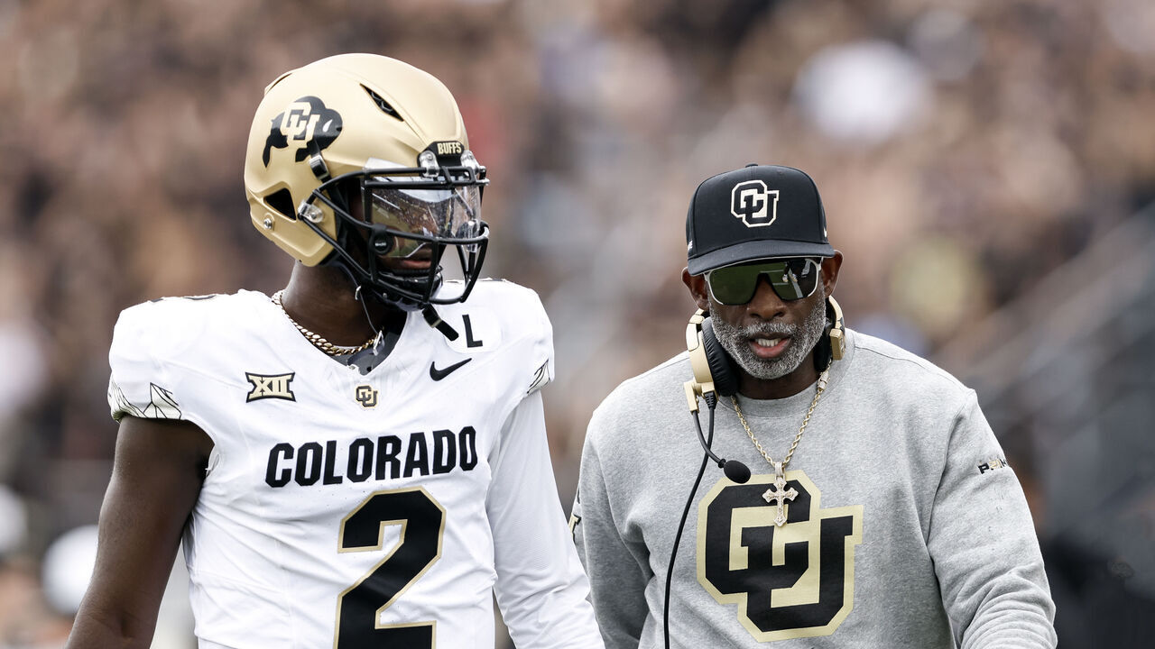ORLANDO, FL - SEPTEMBER 28: Quarterback Shedeur Sanders #2 talk with Head Coach Deion Sanders of the Colorado Buffaloes prior to the game against the UCF Knights at FBC Mortgage Stadium on September 28, 2024 in Orlando, Florida. The Buffaloes defeated the Knights 48-21.