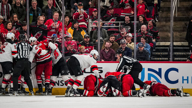 RALEIGH, NORTH CAROLINA - DECEMBER 28: Carolina Hurricanes and New Jersey Devils players fight during the third period at Lenovo Center on December 28, 2024 in Raleigh, North Carolina.