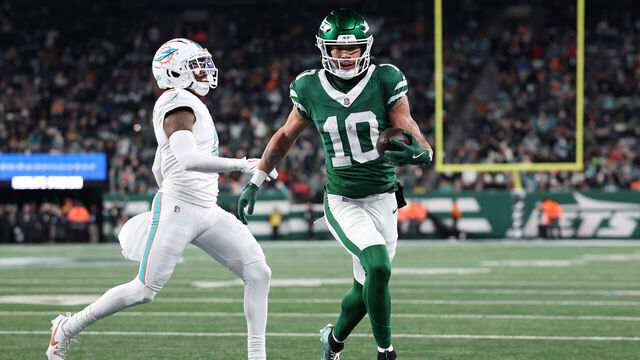 EAST RUTHERFORD, NEW JERSEY - JANUARY 05: Allen Lazard #10 of the New York Jets scores a touchdown against the Miami Dolphins during the second quarter at MetLife Stadium on January 05, 2025 in East Rutherford, New Jersey.