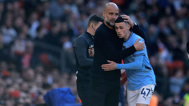MANCHESTER, ENGLAND - APRIL 06: Pep Guardiola, Manager of Manchester City, embraces Phil Foden of Manchester City as he leaves the pitch during the Premier League match between Manchester United FC and Manchester City FC at Old Trafford on April 06, 2025 in Manchester, England.
