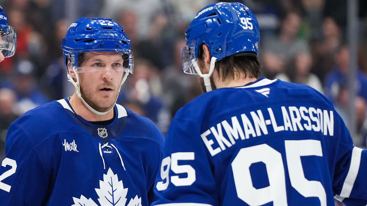 TORONTO, CANADA - OCTOBER 21: Jake McCabe #22, Auston Matthews #34, and Oliver Ekman-Larsson #95 of the Toronto Maple Leafs talk during a game against the Tampa Bay Lightning at Scotiabank Arena on October 21, 2024 in Toronto, Ontario, Canada.