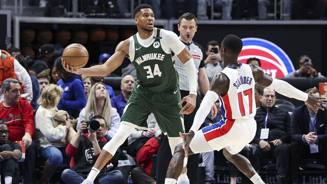 DETROIT, MICHIGAN - APRIL 11: Giannis Antetokounmpo #34 of the Milwaukee Bucks looks to pass the ball while being guarded by Dennis Schroder #17 of the Detroit Pistons during the fourth quarter of a game at Little Caesars Arena on April 11, 2025 in Detroit, Michigan.