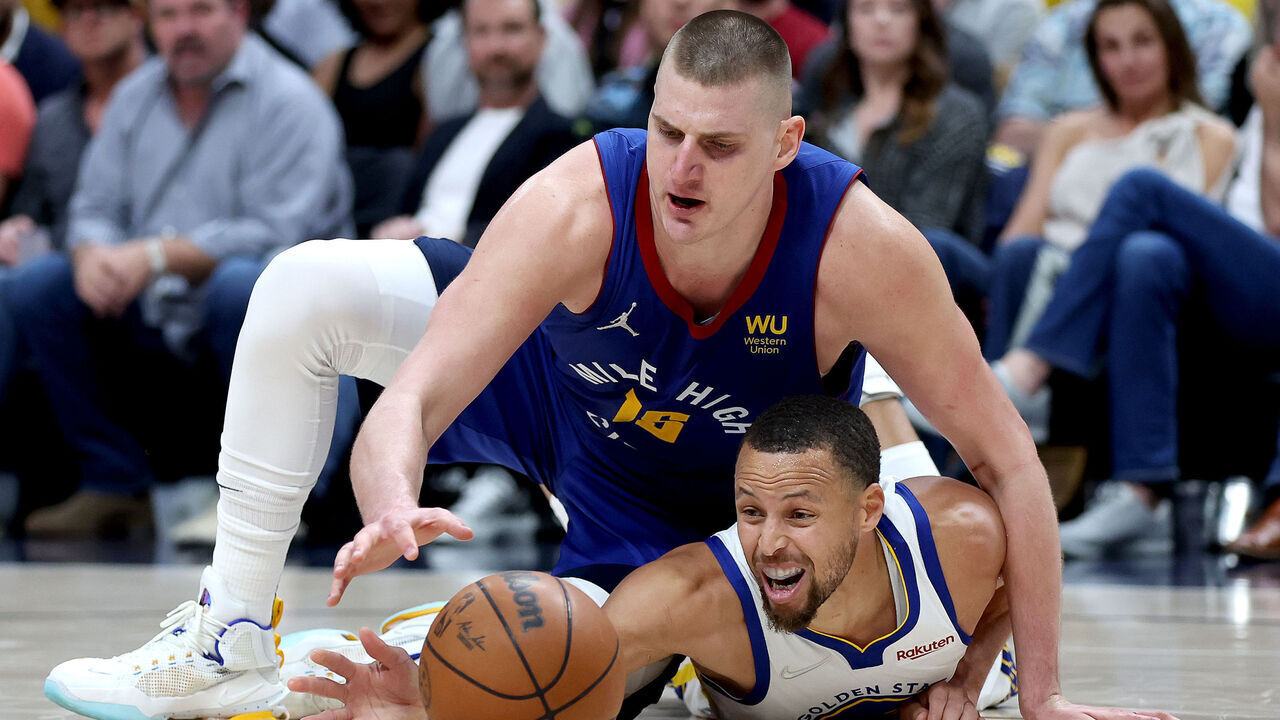 DENVER, COLORADO - APRIL 21: Nikola Jokic #15 of the Denver Nuggets fights for a loose ball against Stephen Curry #30 of the Golden State Warriors in the fourthquarter during Game Three of the Western Conference First Round NBA Playoffs at Ball Arena on April 21, 2022 in Denver, Colorado. NOTE TO USER: User expressly acknowledges and agrees that, by downloading and/or using this photograph, User is consenting to the terms and conditions of the Getty Images License Agreement.
