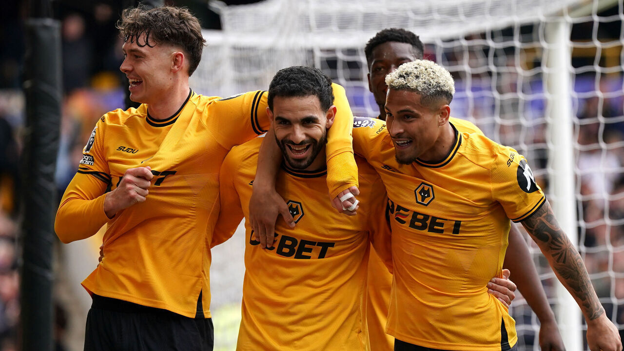 Wolverhampton Wanderers' Jorgen Larsen (left) celebrates scoring their side's third goal of the game during the Premier League match at Molineux Stadium, Wolverhampton. Picture date: Sunday April 13, 2025.