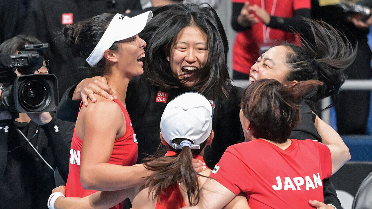 Members of the Japan team celebrate the overall victory after Japan's Shuko Aoyama (front C) and Ena Shibahara (L) beat Canada's Kayla Cross and Rebecca Marino in the women's doubles match between Japan and Canada in Tokyo on April 13, 2025, on the final day of the 2025 Billie Jean King Cup tennis Group A qualifier between Japan, Canada and Romania.
