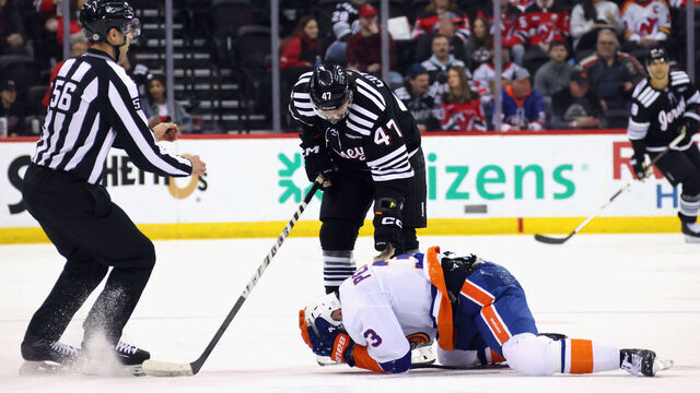 NEWARK, NEW JERSEY - APRIL 13: Adam Pelech #3 of the New York Islanders reacts to a high hit from Paul Cotter #47 of the New Jersey Devils during the second period at Prudential Center on April 13, 2025 in Newark, New Jersey.
