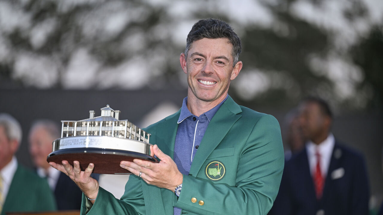 AUGUSTA, GEORGIA - APRIL 13: Rory McIlroy of Northern Ireland smiles with the Green Jacket and tournament trophy following his playoff victory during the final round of the Masters Tournament at Augusta National Golf Club on April 13, 2025 in Augusta, Georgia.