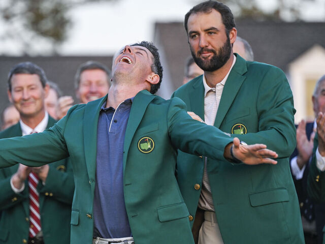 AUGUSTA, GEORGIA - APRIL 13: Rory McIlroy of Northern Ireland smiles during the Green Jacket and trophy presentation ceremony with Scottie Scheffler following his playoff victory in the final round of the Masters Tournament at Augusta National Golf Club on April 13, 2025 in Augusta, Georgia.