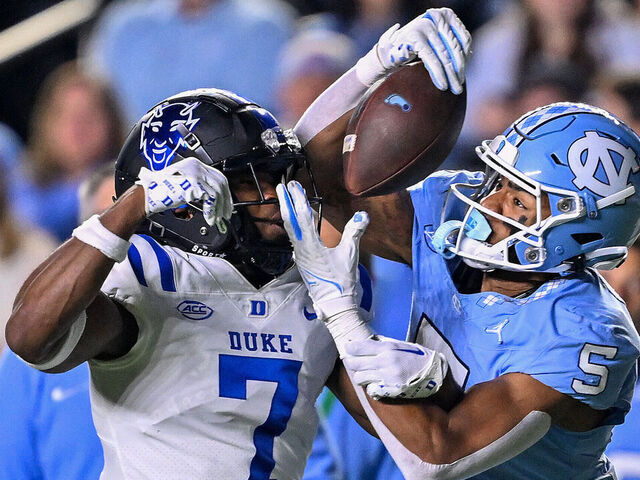 CHAPEL HILL, NORTH CAROLINA - NOVEMBER 11: J.J. Jones #5 of the North Carolina Tar Heels makes a catch against Al Blades Jr. #7 of the Duke Blue Devils during the first half of the game at Kenan Memorial Stadium on November 11, 2023 in Chapel Hill, North Carolina.