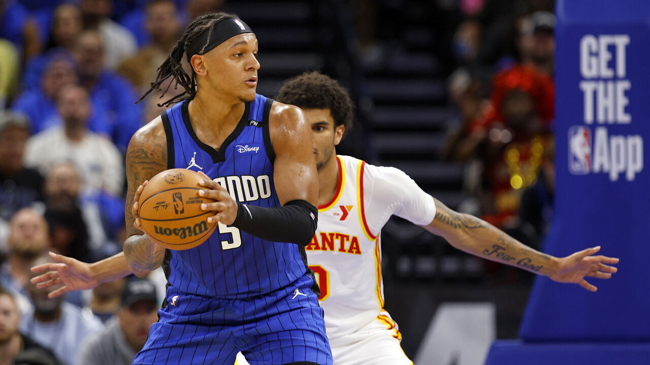 ORLANDO, FLORIDA - APRIL 15: Paolo Banchero #5 of the Orlando Magic posts up Zaccharie Risacher #10 of the Atlanta Hawks during the first half of an NBA play-in tournament game at Kia Center on April 15, 2025 in Orlando, Florida.