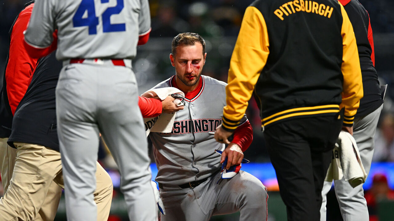 PITTSBURGH, PA - APRIL 15: Staff attends to Paul DeJong #14 of the Washington Nationals after he was hit by a pitch in the sixth inning during the game between the Washington Nationals and the Pittsburgh Pirates at PNC Park on Tuesday, April 15, 2025 in Pittsburgh, Pennsylvania.