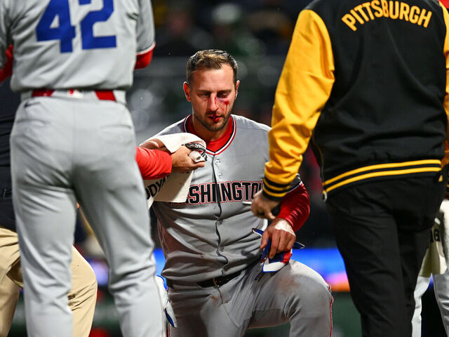 PITTSBURGH, PA - APRIL 15: Staff attends to Paul DeJong #14 of the Washington Nationals after he was hit by a pitch in the sixth inning during the game between the Washington Nationals and the Pittsburgh Pirates at PNC Park on Tuesday, April 15, 2025 in Pittsburgh, Pennsylvania.