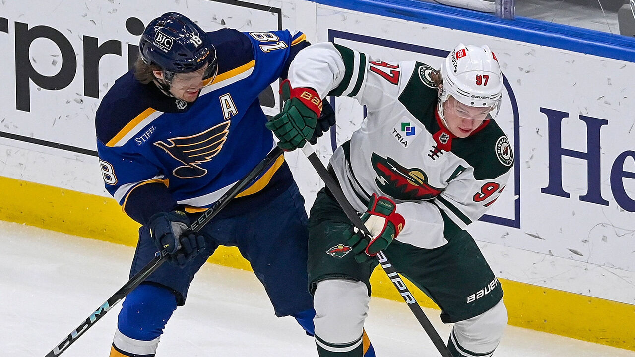 ST. LOUIS, MO - NOVEMBER 19: Robert Thomas #18 of the St. Louis Blues and Kirill Kaprizov #97 of the Minnesota Wild battle for the puck on November 19, 2024 at the Enterprise Center in St. Louis, Missouri.