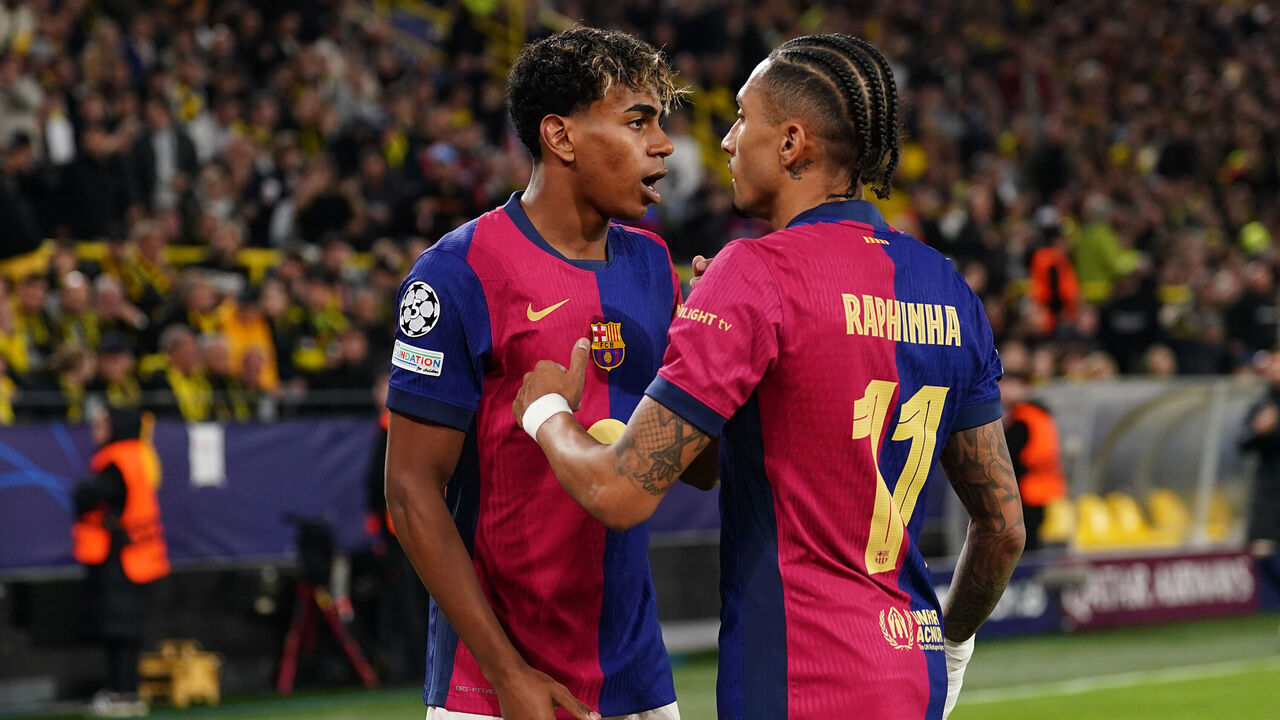 DORTMUND, GERMANY - APRIL 15: (L-R) Lamine Yamal of FC Barcelona , Raphinha of FC Barcelona celebrate the third goal 2-1 during the UEFA Champions League match between Borussia Dortmund v FC Barcelona at the Signal Iduna Park on April 15, 2025 in Dortmund Germany